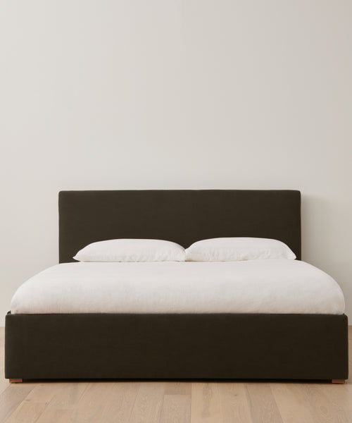 The Pacific Bed features a white Belgian Libeco linen bedding set and an upholstered headboard.
